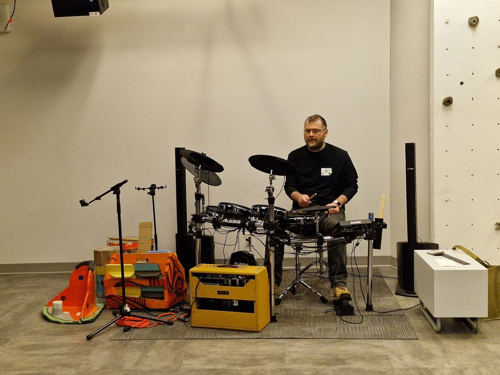 A person playing drums in Re/Lab.